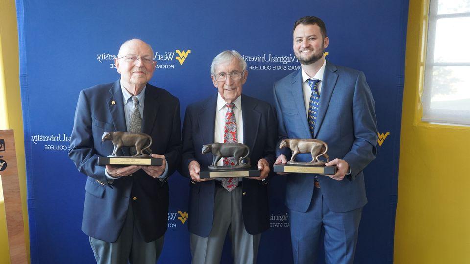 2023 alumni winners pose for a portrait with their awards